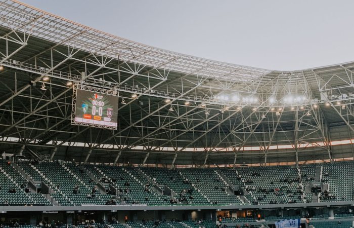 A spacious, modern sports stadium in Kocaeli, Türkiye, illuminated during sunset.