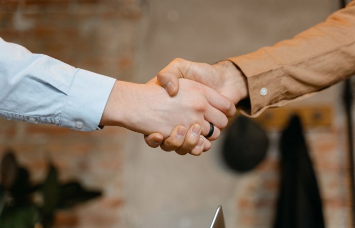 Close-up of a firm handshake symbolizing a business deal agreement.