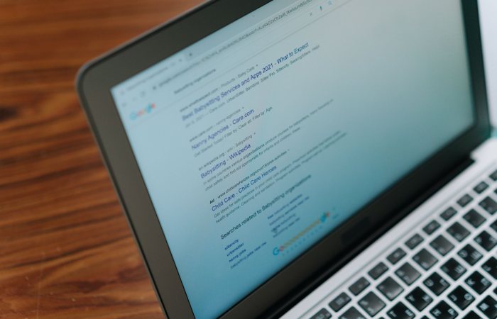 A close-up view of a laptop displaying a search engine page.