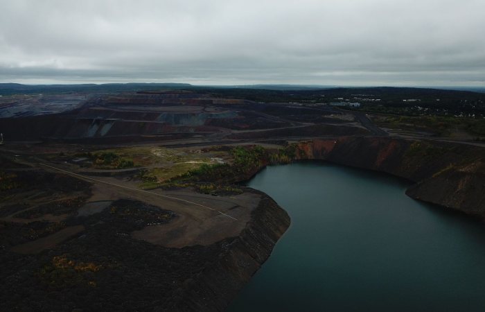 Aerial view of mine lake and surrounding landscape in Eveleth, Minnesota, on an overcast day.